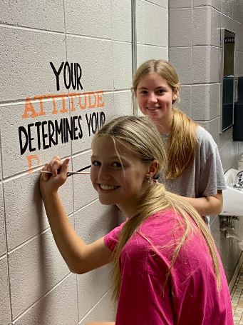 Freshmen Dakota Gray and McKenna Channell help with a mural in the bathroom. This is the other of the two murals in the bathroom.
