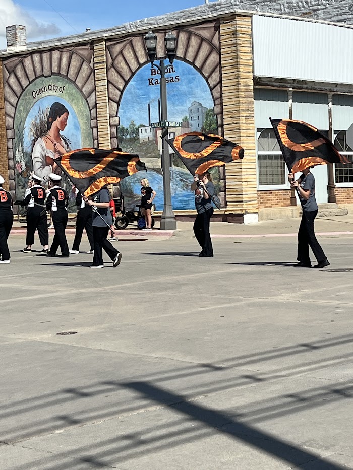 Flag team members perform a routine in the recent homecoming parade. Some team members are also helping with the youth flag camp.`
